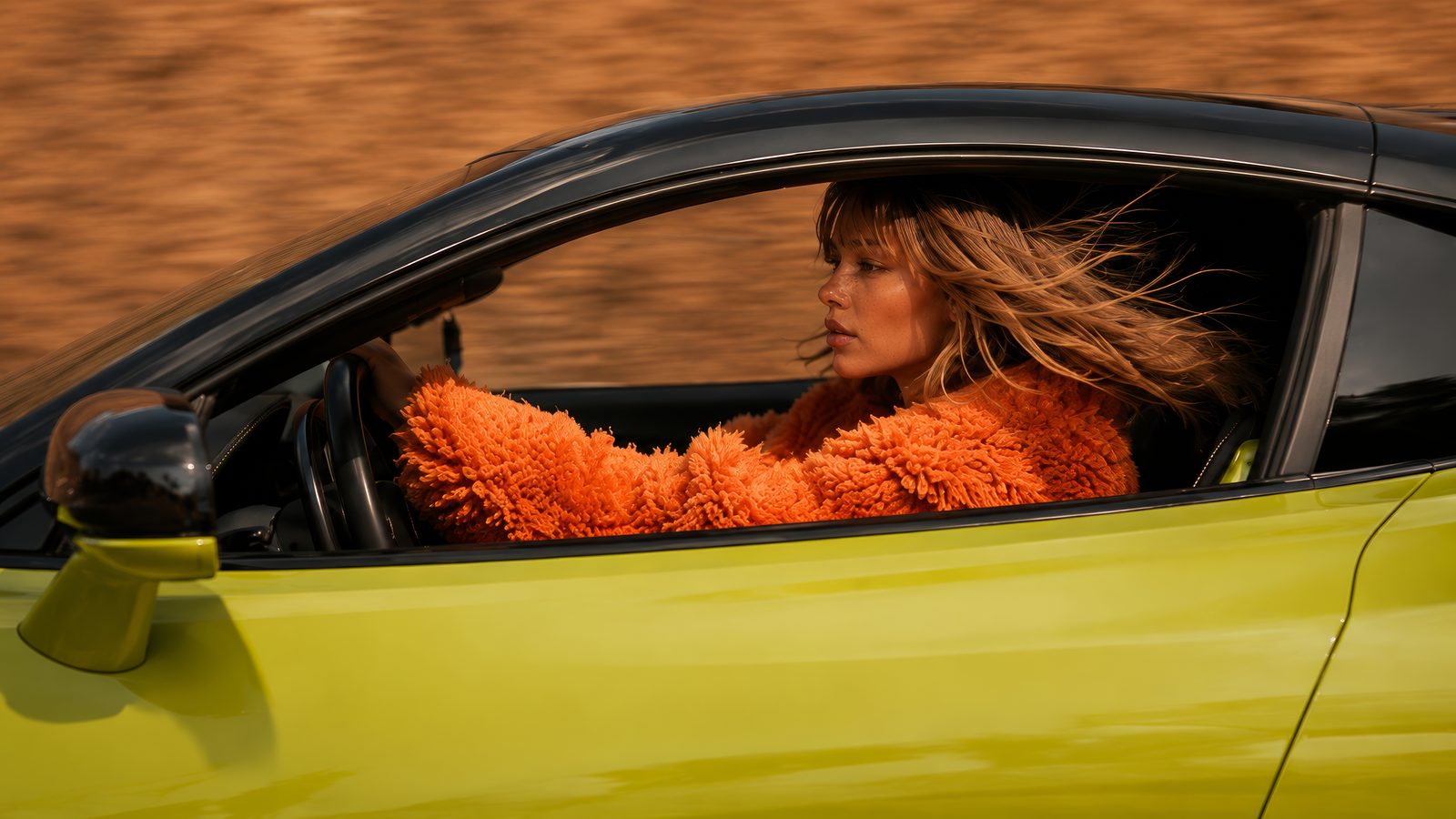 Solenne driving, seen through the side window, the background streaked with speed