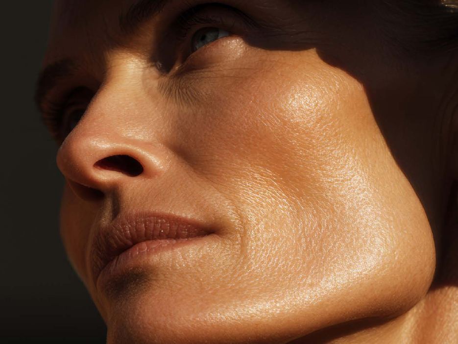 Close portrait of a woman's face in hard sunlight, skin texture fully visible